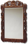 Ornate and decoratively carved Teak colour framed Mirror