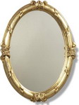 Elaborately carved and decorated in gold leaf period oval mirror.