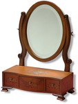 Late 18th Century Period Style, this small dressing table mirror with three drawers and delicate detailing is a charming replica of the Georgian period and features an oval mirror, fully adjustable which sits above an oblong base and wooden feet.