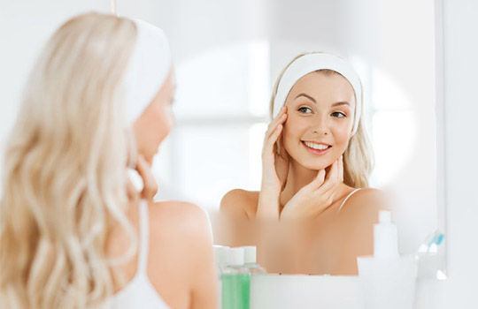 Girl using mirror fitted with Clearview heated mirror pad