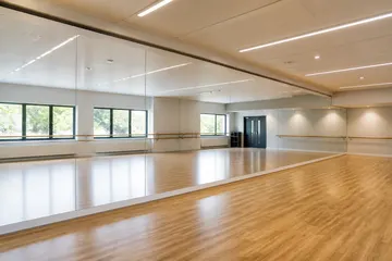 Large studio mirrors installed in a dance or rehearsal space